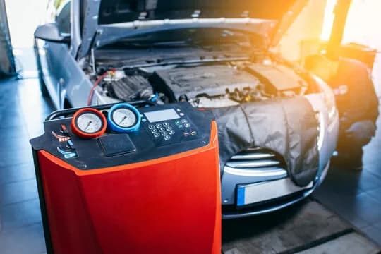 Air conditioning refrigerant recharge machine in a service bay