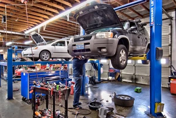 Open service bays with work vehicles on lifts