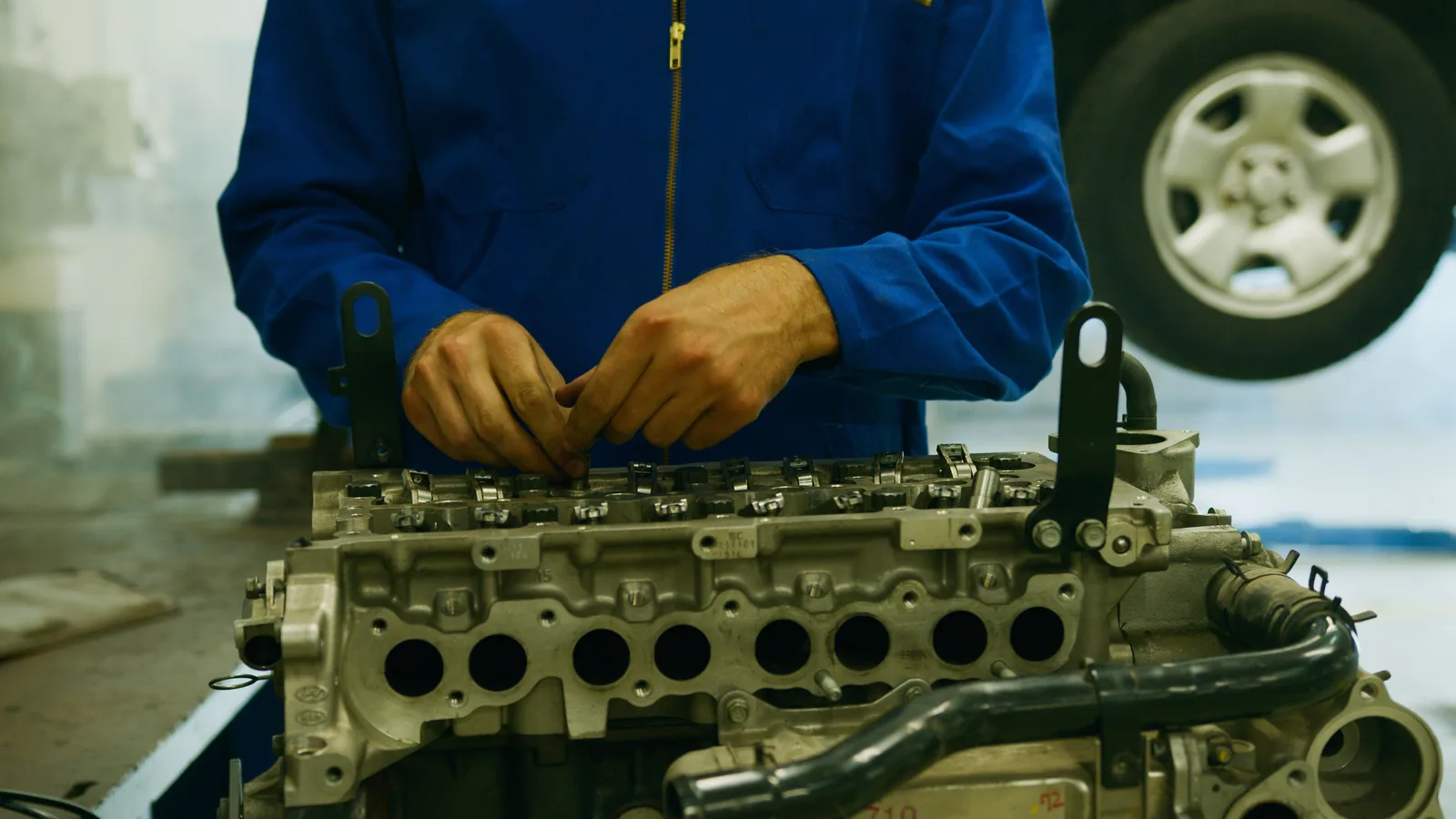 Technician rebuilding an engine cylinder head